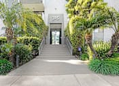 Thumbnail 77 of 95 - A concrete pathway leads to a glass door with the number 315 on it.
