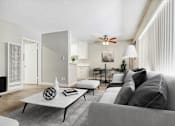 Thumbnail 4 of 15 - A modern living room with a grey couch, a white coffee table, and a ceiling fan.
