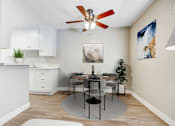 Thumbnail 3 of 15 - A dining room with a table set for four.