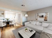 Thumbnail 14 of 34 - A modern living room with a white couch and a coffee table.