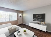 Thumbnail 15 of 34 - A living room with a white couch, a coffee table, and a flat screen TV mounted on the wall.