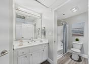 Thumbnail 7 of 41 - A white bathroom with a toilet, sink, and mirror.