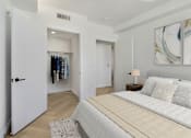 Thumbnail 5 of 31 - A bedroom with a large bed and a wardrobe.