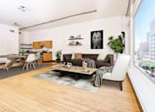 Thumbnail 2 of 37 - a living room with a couch and a table and a large window