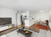 Thumbnail 4 of 6 - a living room with a couch and a table and a television