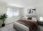 Thumbnail 5 of 6 - an example of a bedroom with a bed and a potted plant