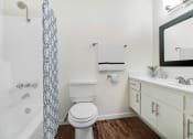 Thumbnail 6 of 6 - a bathroom with a toilet and a sink and a mirror