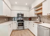 Thumbnail 3 of 50 - Modern stainless steel appliances with Tile backsplash