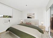Thumbnail 117 of 127 - A bedroom with a large bed and a window with blinds.