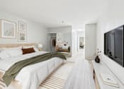 Thumbnail 116 of 127 - A modern bedroom with a large bed and a flat screen TV on the wall.