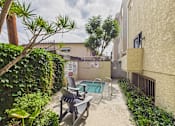 Thumbnail 36 of 115 - A small pool surrounded by a concrete patio and a black metal railing.