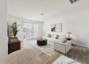 Thumbnail 4 of 115 - A living room with a white couch and a coffee table.