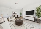 Thumbnail 2 of 115 - A living room with a white couch, a brown ottoman, and a black and white rug.