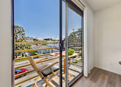 Thumbnail 6 of 115 - A chair is placed in front of a sliding glass door.