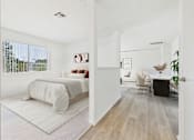 Thumbnail 7 of 115 - A bedroom with a bed and a chair in it.