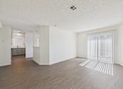 Thumbnail 32 of 115 - A room with wooden flooring and white walls.