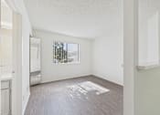 Thumbnail 31 of 115 - A room with a window and a wooden floor.