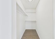 Thumbnail 34 of 115 - A long, narrow room with a white ceiling and a wooden floor.