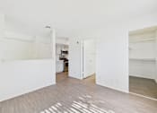 Thumbnail 27 of 115 - A white room with a wooden floor and a white door.
