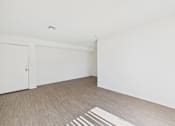 Thumbnail 33 of 115 - A room with a white door and a white wall.