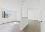 Thumbnail 28 of 115 - A white room with a door and a window.