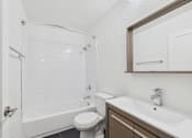 Thumbnail 78 of 92 - A white toilet sits next to a white sink in a small bathroom.