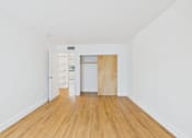 Thumbnail 75 of 92 - A room with a wooden floor and a white wall.