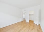 Thumbnail 85 of 92 - A room with wooden floors and white walls.