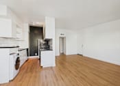 Thumbnail 82 of 92 - A kitchen with white cabinets and a wooden floor.