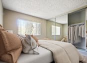 Thumbnail 5 of 33 - A bedroom with a bed, pillows, and a mirror.