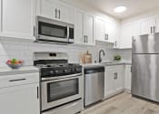 Thumbnail 45 of 66 - a kitchen with white cabinets and stainless steel appliances