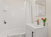 Thumbnail 49 of 66 - a bathroom with a sink and a bathtub