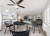 Thumbnail 15 of 19 - A modern kitchen with a dining table and chairs.