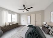 Thumbnail 2 of 19 - A bedroom with a bed, a chair, and a ceiling fan.