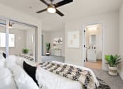 Thumbnail 58 of 66 - a bedroom with a large bed and a ceiling fan