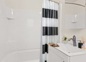 Thumbnail 59 of 66 - a white bathroom with a black and white shower curtain