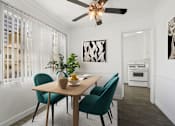Thumbnail 12 of 26 - A dining room with a table, chairs, and a ceiling fan.