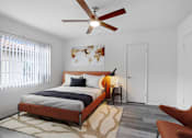 Thumbnail 7 of 26 - A bedroom with a bed, a chair, and a ceiling fan.