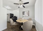 Thumbnail 2 of 32 - A dining room with a table and chairs.