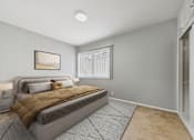 Thumbnail 6 of 32 - A bedroom with a large bed and a framed picture on the wall.