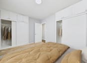 Thumbnail 5 of 32 - A bedroom with a bed and a wardrobe.