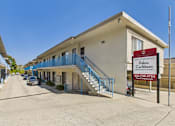Thumbnail 19 of 19 - A building with a sign that says Palms Caribbean Apartment Homes.