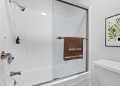 Thumbnail 13 of 48 - a bathroom with a shower and a toilet and a sink