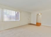 Thumbnail 10 of 14 - Living room with carpet flooring, vertical blinds on the windows