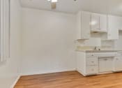 Thumbnail 8 of 14 - Dining area with Ceiling Fan, wood-inspired floors, kitchen on the right