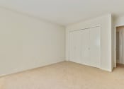 Thumbnail 12 of 14 - Bedroom with sliding closet doors, carpet flooring
