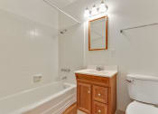 Thumbnail 14 of 14 - Bathroom with tub and shower combo, single round vanity with wood texture, wood-style flooring