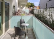 Thumbnail 4 of 12 - a small balcony with two chairs and a table