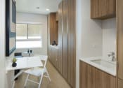 Thumbnail 13 of 16 - a home office with a desk and a sink
