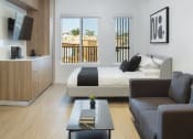 Thumbnail 11 of 16 - a bedroom with a bed and a couch and a coffee table